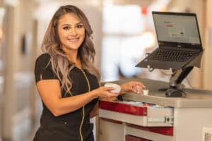 A nurse standing in the hallway next to a nurse's cart at Gateway